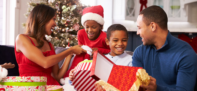 family opening christmas presents at home together