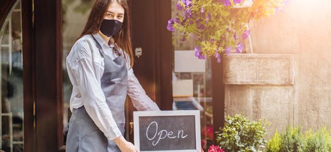 coronavirus covid 19. floral shop woman owner with face mask, open after lockdown quarantine. end quarantine. announcement we are open nv doors, flower shops, cafes,coffee houses, small businesses