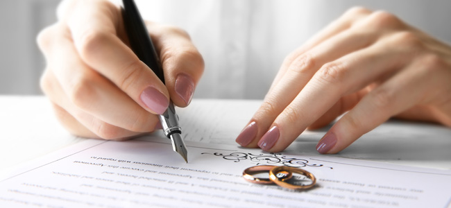woman signing marriage contract, closeup
